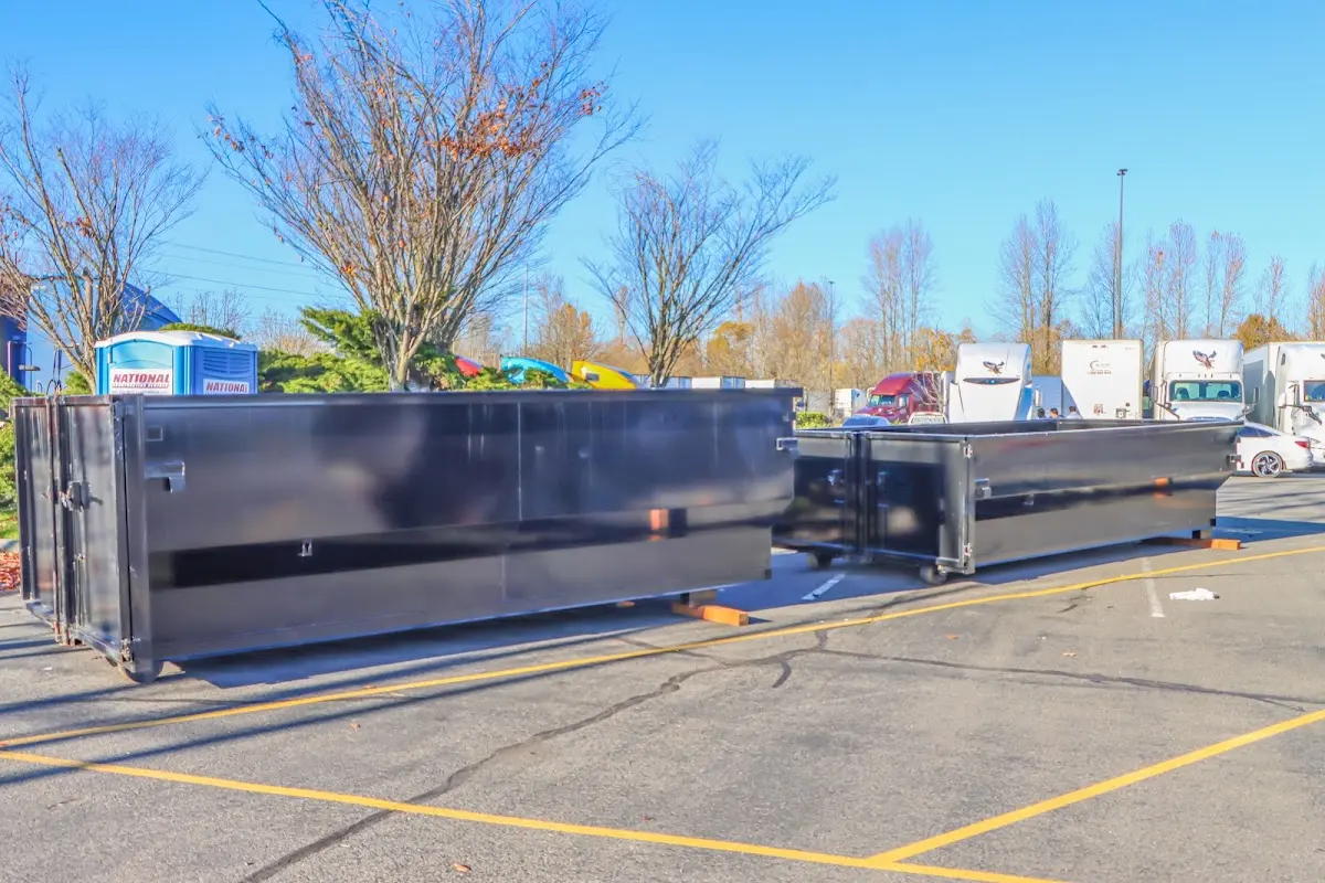Professional dumpster rental service with roll-off container on residential driveway in Absecon